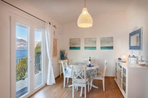 a dining room with a table and a view of the ocean at Il Nido in Brenzone sul Garda