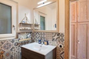 a bathroom with a sink and a mirror at Il Nido in Brenzone sul Garda