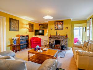 a living room with a couch and a fireplace at 3 Bed in Brecon oc-93947 in Llanywern