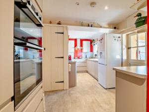 a kitchen with white cabinets and a refrigerator at 3 Bed in Brecon oc-93947 in Llanywern +23 photos