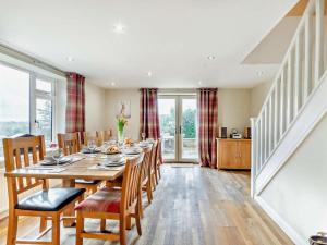 a dining room with a long table and chairs at 4 Bed in Matlock oc-93830 in Crich