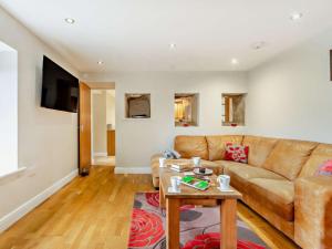 a living room with a couch and a table at 4 Bed in Matlock oc-93830 in Crich