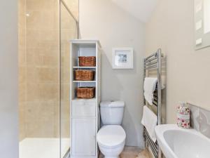 a bathroom with a toilet and a shower and a sink at 4 Bed in Matlock oc-93830 in Crich +21 photos
