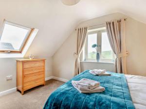 a bedroom with a bed and a window at 4 Bed in Matlock oc-93830 in Crich