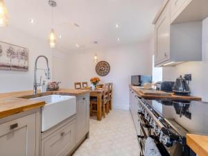 a kitchen with white cabinets and a sink at 2 Bed in Hope Valley oc-94552 in Bradwell