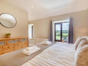 a bedroom with a bed with a mirror and a window at 2 Bed in Hope Valley oc-94552 in Bradwell