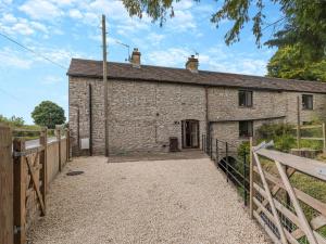 a stone cottage with a wooden fence around it at 2 Bed in Hope Valley oc-94552 in Bradwell +15 photos