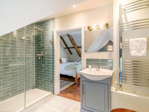 a bathroom with a glass shower and a sink at 5 Bed in Crickhowell oc-90053 in Crickhowell +54 photos