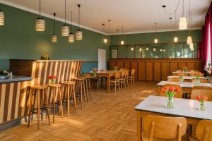 a restaurant with tables and chairs and a bar at KulturHaus Locktow in Locktow