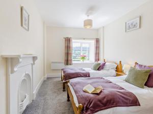 two beds in a room with a window at 6 Bed in Okehampton oc-estra in Okehampton