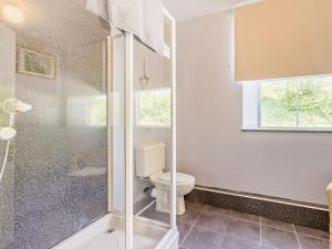 a bathroom with a toilet and a glass shower at 6 Bed in Okehampton oc-estra in Okehampton +28 photos
