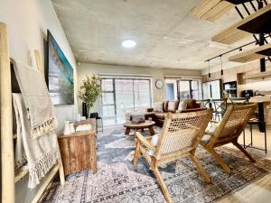 a living room with wicker chairs and a couch at Rustic Hills #25 in Swakopmund