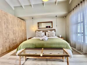 a bedroom with a large bed and a large window at Rustic Hills #25 in Swakopmund