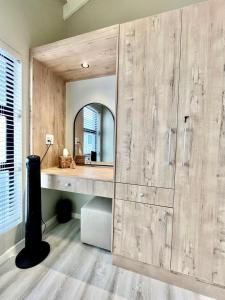a bathroom with a large wooden wall with a mirror at Rustic Hills #25 in Swakopmund +7 photos
