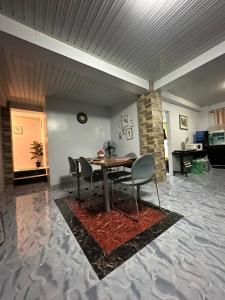 a dining room with a table and chairs at Koenigs Lodging House in Bocaue