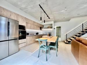 a kitchen with a table and chairs and a refrigerator at Rustic Hills #25 in Swakopmund
