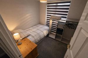 a small room with a small bed and a table at Cloverdale in Bedlington