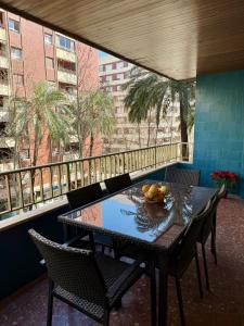 a table with a bowl of fruit on a balcony at Apartamento Tibi - centro de Gandia in Gandía