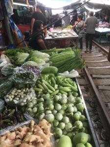 a market filled with lots of fruits and vegetables at Baan Farang in Samut Songkhram