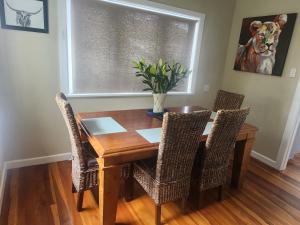 a dining room table with chairs and a window at Cambridge Oasis in Cambridge +6 photos