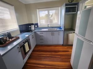 a kitchen with white cabinets and a sink and a window at Cambridge Oasis in Cambridge
