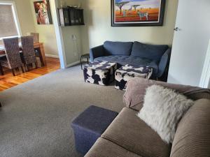 a living room with a couch and a table at Cambridge Oasis in Cambridge
