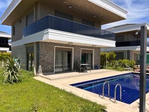 a house with a swimming pool in front of it at Nirvana Belek Villas Manolya in Belek