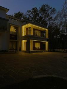a large building with its lights on at night at Vijay Home Stays in Batheri
