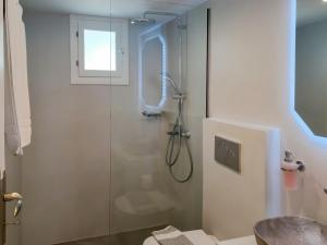 a bathroom with a shower with a glass door at Boufounis Studios in Kamares +75 photos