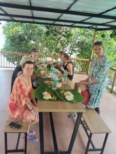 a group of people sitting at a table with food at Lake view Resort cherai in Cherai Beach