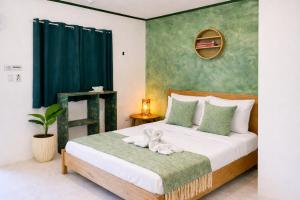 a bedroom with a bed with a stuffed animal on it at Lelija Apartment in General Luna