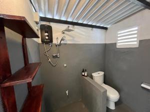a small bathroom with a toilet and a shower at Hiricurry,Rooms Hostel & Restaurant in Dickwella +73 photos