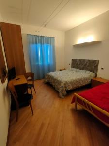 a bedroom with a bed and a table and a desk at B&B Ca' Vecchia in Budrio