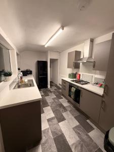 a kitchen with a sink and a counter top at Contractor Friendly 4 Bed House XBOX Sleeps 6 in Newark-on-Trent +21 photos