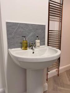 a white sink in a bathroom with a mirror at Contractor Friendly 4 Bed House XBOX Sleeps 6 in Newark-on-Trent