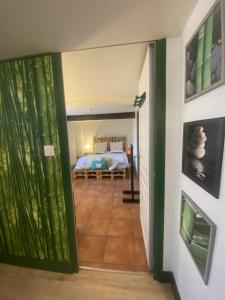 a door leading to a bedroom with a bed at Chambre Le Colibri in Lezoux