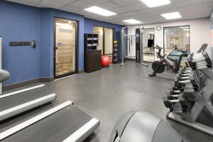 a gym with treadmills and machines in a room at Hampton Inn Frostburg in Frostburg