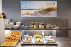 a buffet line with food and plates of food at Hotel zur Traube in Kühlungsborn