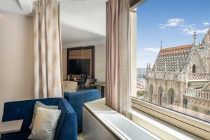 a room with a view of a church from a window at Hilton Budapest in Budapest