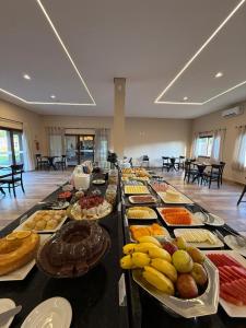 a buffet of food on a long table at Pousada Maritaca in Bonito