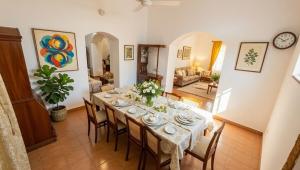 a dining room with a table and chairs at Abraham's 4 BHK villa, By Gonserv in Jāmb