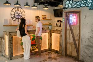 a man and a woman standing at a hostess counter at HOST'S EL Fisherman in Nathon Bay