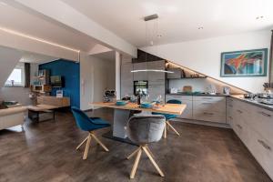 a kitchen with a table and chairs in a room at Grünten-Chalet in Oy-Mittelberg +9 photos