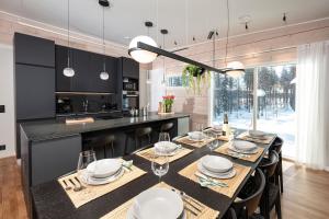 a kitchen and dining room with a table and chairs at Villa Kannas 1 in Juuka
