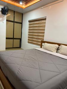 a bedroom with a large bed and a window at ARAMAM SERVICE VIlla in Mananthavady +4 photos