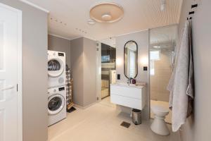 a bathroom with a washing machine and a washer and dryer at Villa Kannas 1 in Juuka +32 photos