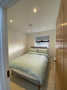 a bedroom with a large bed with a window at Lakeview in Keel