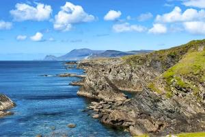 a large body of water next to a rocky coast at Lakeview in Keel +16 photos