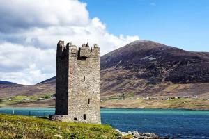 a castle in the middle of a body of water at Lakeview in Keel
