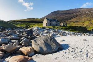 an old church on the shore of a rocky beach at Lakeview in Keel